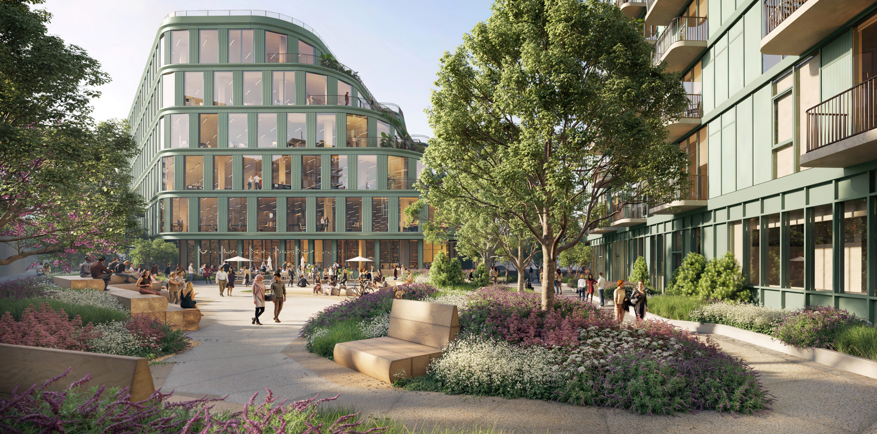 View past Habitat's apartment building through the Los Angeles campus's park setting to the commercial office space